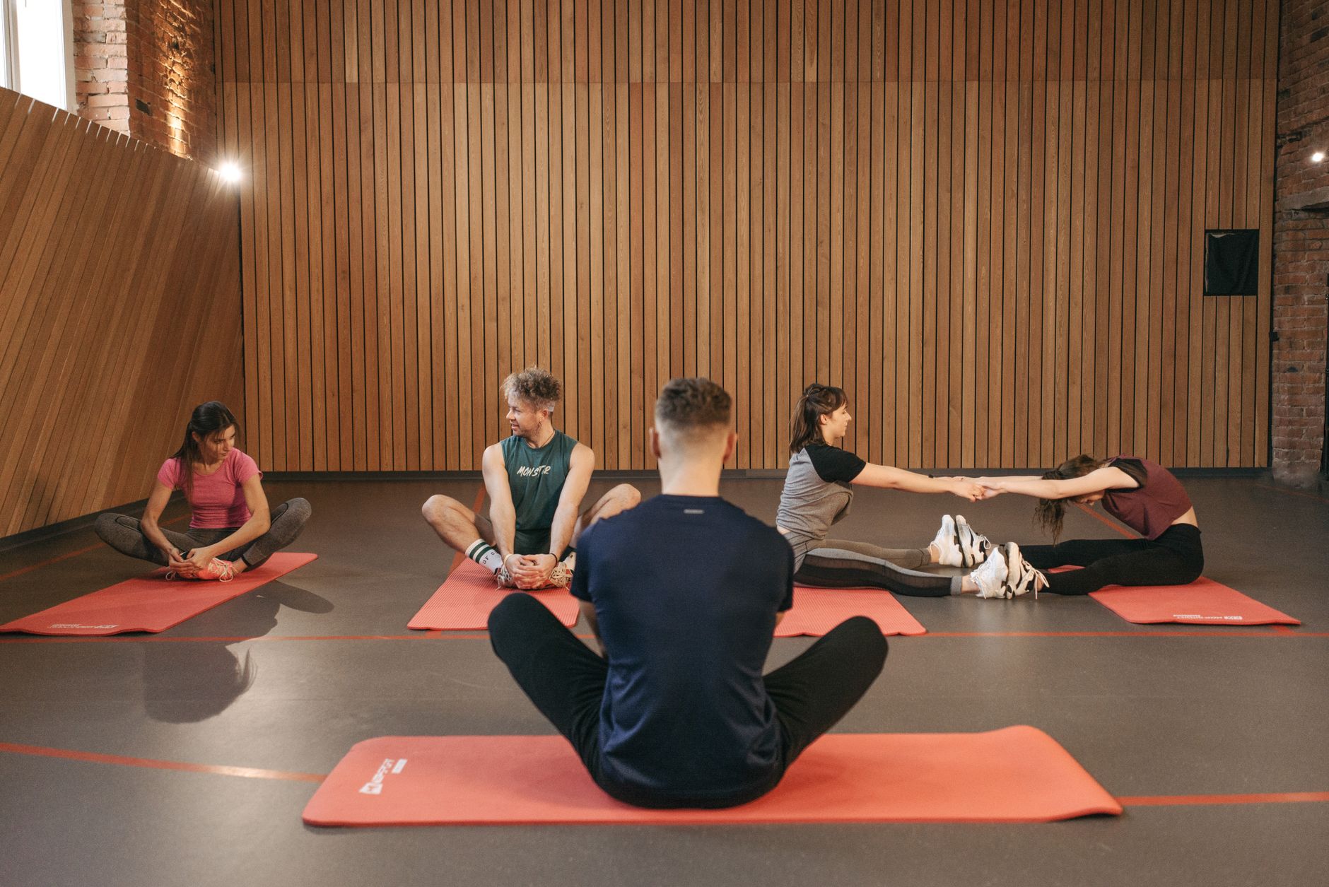 People on red mats for movement prep